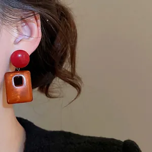 Retro acrylic square earrings with red studs and amber geometric hollow pendants