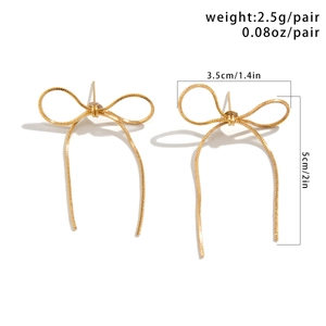 Close-up of golden bow earrings with precise dimensions 3.5cm by 5cm and detailed texture