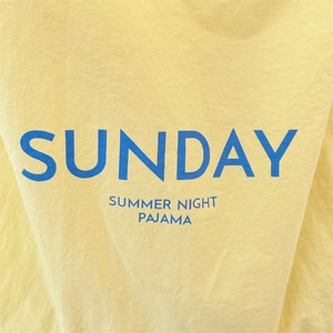 Detailed close-up of blue SUNDAY print on yellow cotton canvas tote bag fabric texture