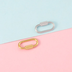 Close-up of gold and silver oval screw-lock connectors for DIY jewelry and keychains
