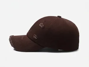 Detail shot of distressed dark coffee cotton baseball cap with worn edges and rip effects
