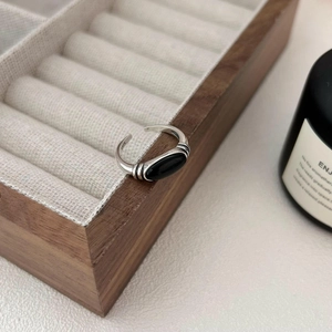 Elegant 925 sterling silver ring with oval black onyx gemstone on wooden jewelry box
