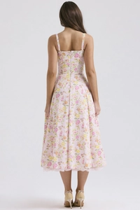 Detail view of pink floral dress featuring hidden back zipper and lace hemline trim