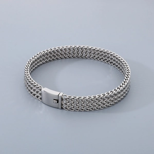 Detailed view of silver braided chain bracelet with multi-layer metal square clasp