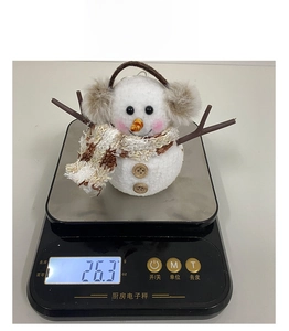Close-up of lightweight snowman ornament weighing 26.3g on a scale for Christmas gifts