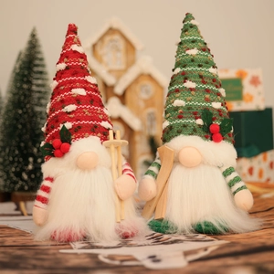 Detail of red and green knitted Christmas gnomes with glowing lights on a festive background