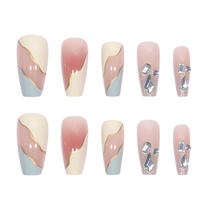French art style press-on nails in dusty blue and cream with gold lines and rhinestones