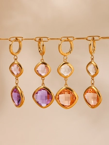 Detail of four 18k gold plated stainless steel earrings with square glass crystals