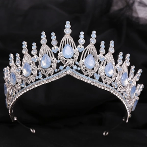 Macro detail of Baroque silver bridal crown featuring teardrop blue crystals on black silk