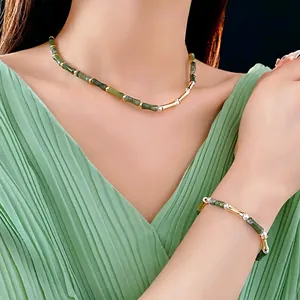 Chinese style bamboo joint jewelry set with green beads and gold accents on a model