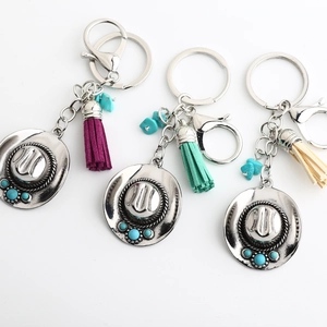 Detail of bohemian cowboy hat keychains with turquoise beads and colorful tassels