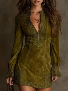 Detail of olive green dress with embroidery, metal zipper and suede texture