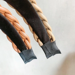 Detailed close-up of woven PU leather and velvet headband ends in brown and beige