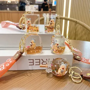 Cute capybara liquid quicksand keychain charms in orange milk tea cup and bottle shapes