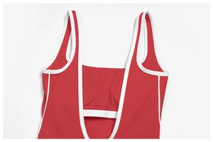 Detail of red square neck yoga bodysuit with white piping and wide shoulder straps