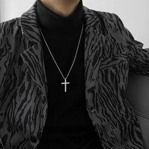 Classic silver titanium steel cross pendant necklace worn by a stylish model