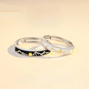 Close-up of Sun and Moon adjustable couple rings with black enamel and silver finish