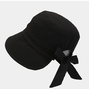 Elegant black seersucker sun hat with a large bow detail and wide brim for sun protection