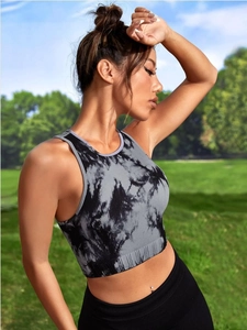 Detail of grey tie-dye seamless yoga vest with ribbed texture on a fitness model