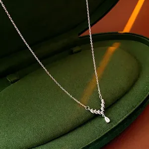 Elegant V-shaped silver necklace with pear-cut cubic zirconia in a green velvet box