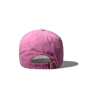 Detail view of pink washed cotton baseball cap with adjustable metal buckle at the back
