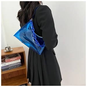 Detail of royal blue transparent PVC underarm bag with acrylic chunky chain strap