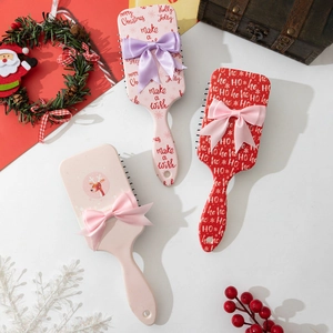 Christmas hairbrush set with festive bows and holiday patterns for scalp massage