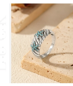 Macro detail of vintage S925 silver starfish ring with turquoise inlay on textured stone