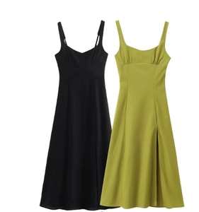 Detail of minimalist midi slip dresses with thin straps and side slits in black and green