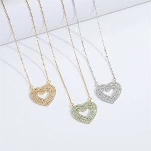 Triple heart pendant necklace in gold and silver finishes with pavé zircon stones