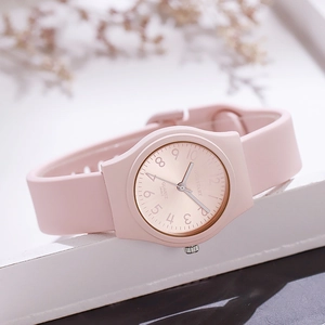Detailed macro view of the pink silicone strap and matte quartz watch case for women