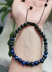 Detailed macro view of Soul Sister Morse code bracelet with blue tiger eye and lava stones
