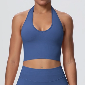 Detail of high-stretch navy blue knitted halter sports bra with ribbed texture and V-neck
