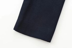 Detailed macro view of the navy blue textured fabric sleeve cuff with fine woven stitching
