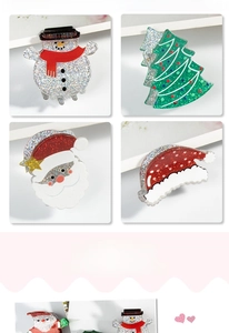 Detail of glitter acrylic Christmas hair clips featuring snowman and Santa Claus designs