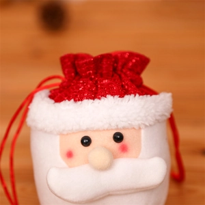 Close-up of Santa Claus drawstring gift bag with soft white plush and red glitter fabric