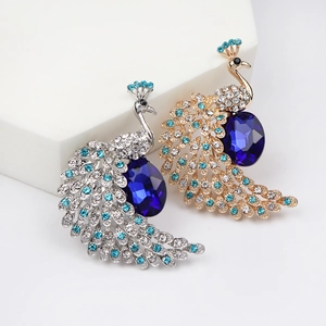 Elegant pair of gold and silver peacock brooches with deep blue crystal and rhinestones