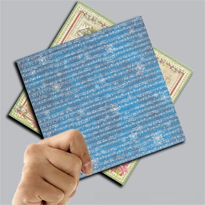 Close-up of vintage Christmas scrapbook paper with music scores and snowflake patterns