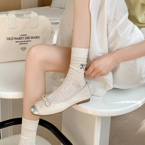 Ballet style cream ribbed mid-calf socks with black bow embroidery and round-toe shoes