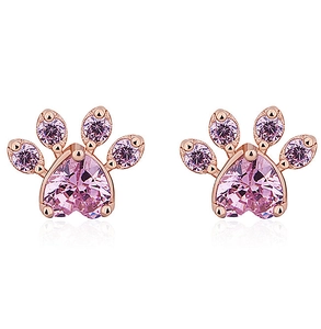 Detailed macro view of rose gold cat paw stud earrings with pink heart-shaped crystals