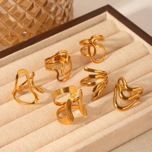 Detailed close-up of 18K gold plated stainless steel irregular rings in a beige velvet box