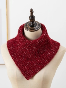 Detail of red cable-knit wool neck warmer with thick texture on mannequin