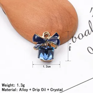 Detailed size view of dark blue enamel bow pendant with square crystal, 1.2x1.4cm