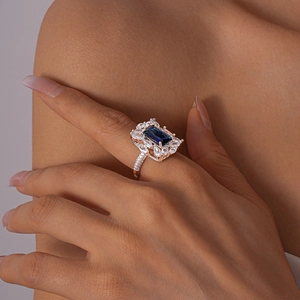 Close-up of a rose gold open ring with blue and white zircon in geometric hollow design