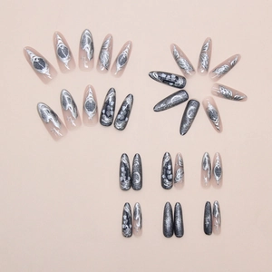 Detailed flat lay of silver butterfly press-on nails with 3D metallic moon star designs