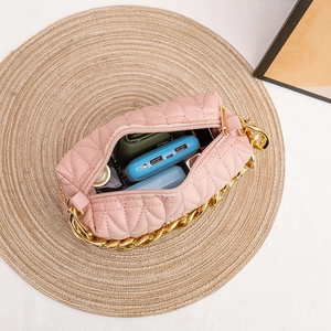 Pink quilted crossbody bag with gold chain strap and spacious interior for phone