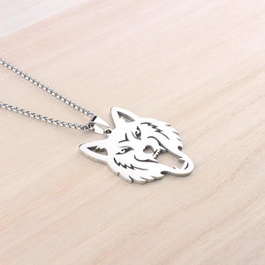Macro view of a silver wolf head pendant with metallic luster on a box chain link