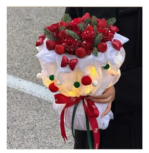 Detailed view of the strawberry and red rose bouquet with festive LED lights and pompoms
