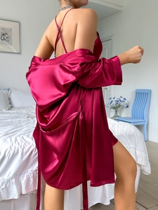Luxurious burgundy satin sleepwear set featuring a midi robe and camisole dress in bedroom
