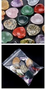 Macro shot of assorted heart-shaped natural healing crystals in bulk and clear packaging